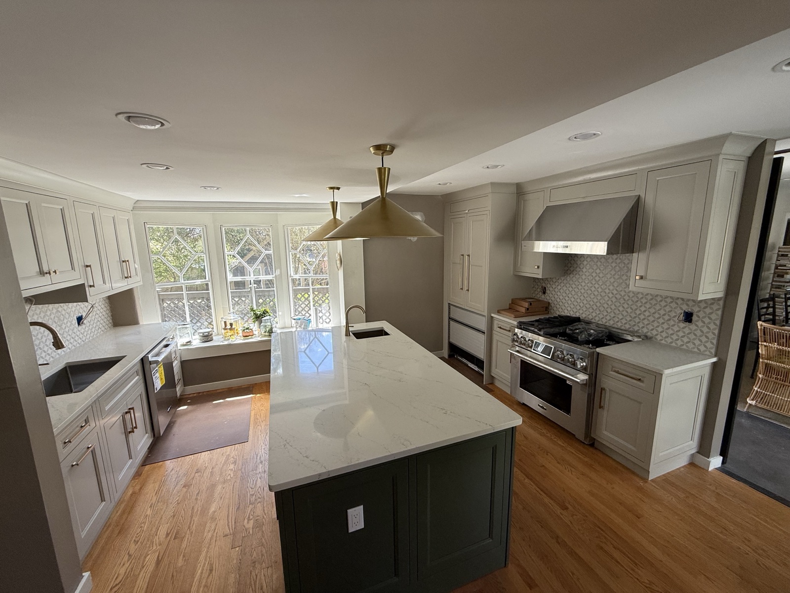 Renovated kitchen with a perimeter sink, an island prep sink, a pro-style range, and new appliance connections